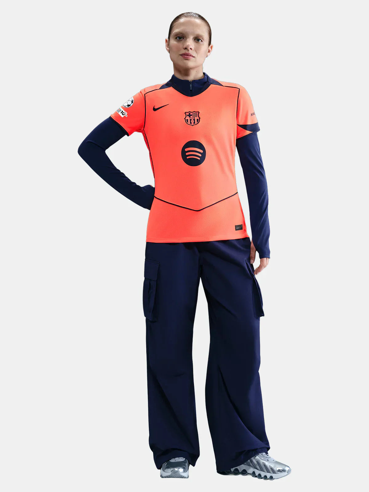 Femenina Barcelona 25/26 third training jersey in orange, navy, Spotify logo