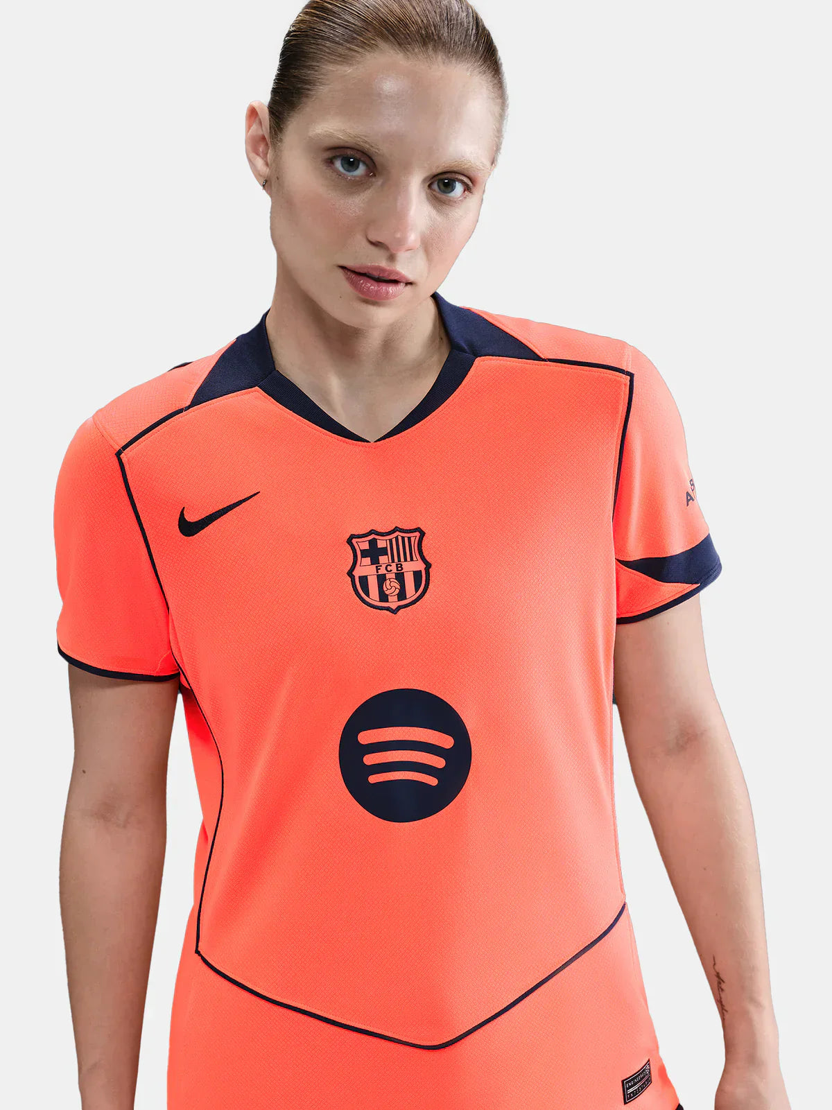 Femenina Barcelona 25/26 third jersey, bright orange with FC Barcelona crest, Spotify logo