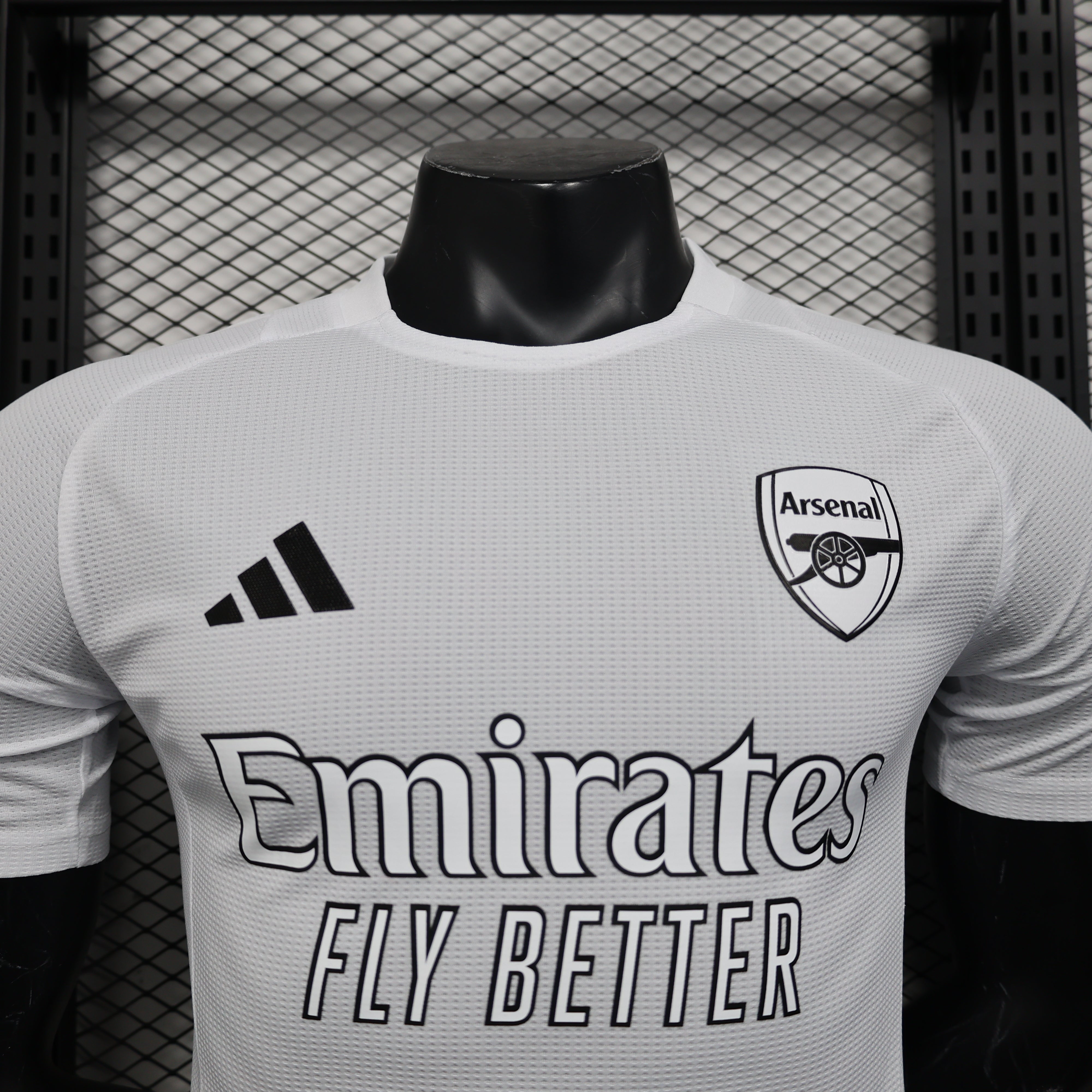 White Arsenal 25/26 player training jersey with black adidas logo