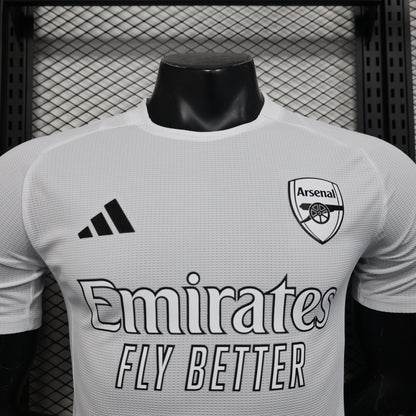 White Arsenal 25/26 player training jersey with black adidas logo
